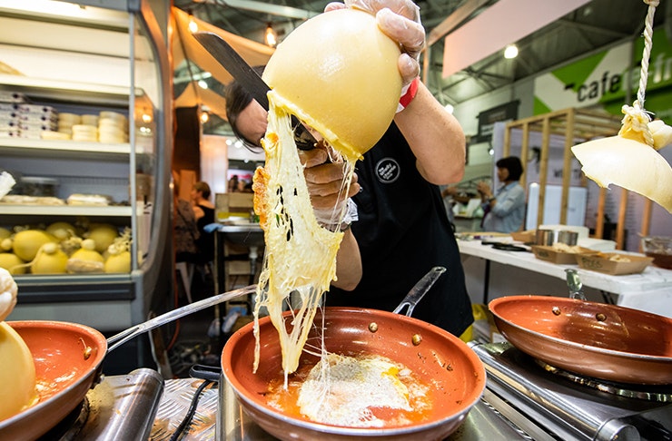A man carving raclette cheese.